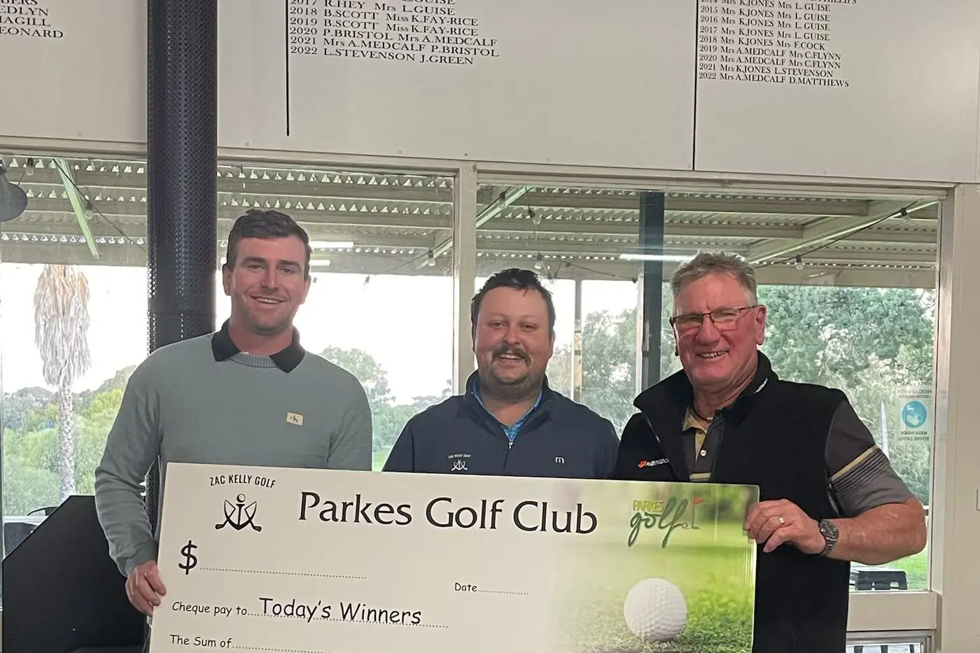 Jake Thompson representing the day\\'s sponsor Parkes Courier Services, and Parkes golf pro Zac Kelly congratulated the net winner in B grade Michael Dellaca. PHOTOS: Parkes Golf Club