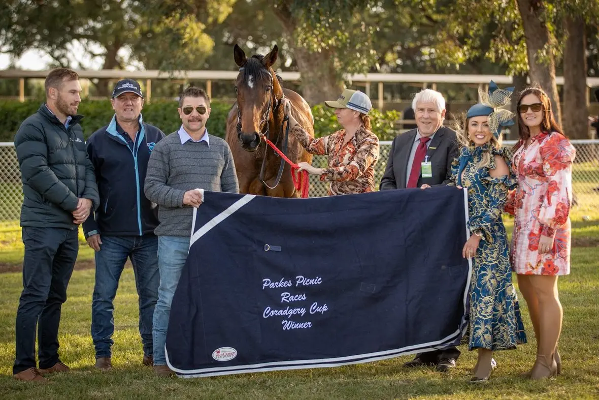 Way to Devine wins the Coradgery Cup at the Parkes Picnic Races on Saturday - Parkes Jockey Club president Alex Prout, Dale Jeffries, owner Michael Hackett, strapper Monique Parsons, Parkes Picnic Races president Tim Keith, Tiffany Prout and Jane Swindle. PHOTOS: Janine McMillan Racing Photography