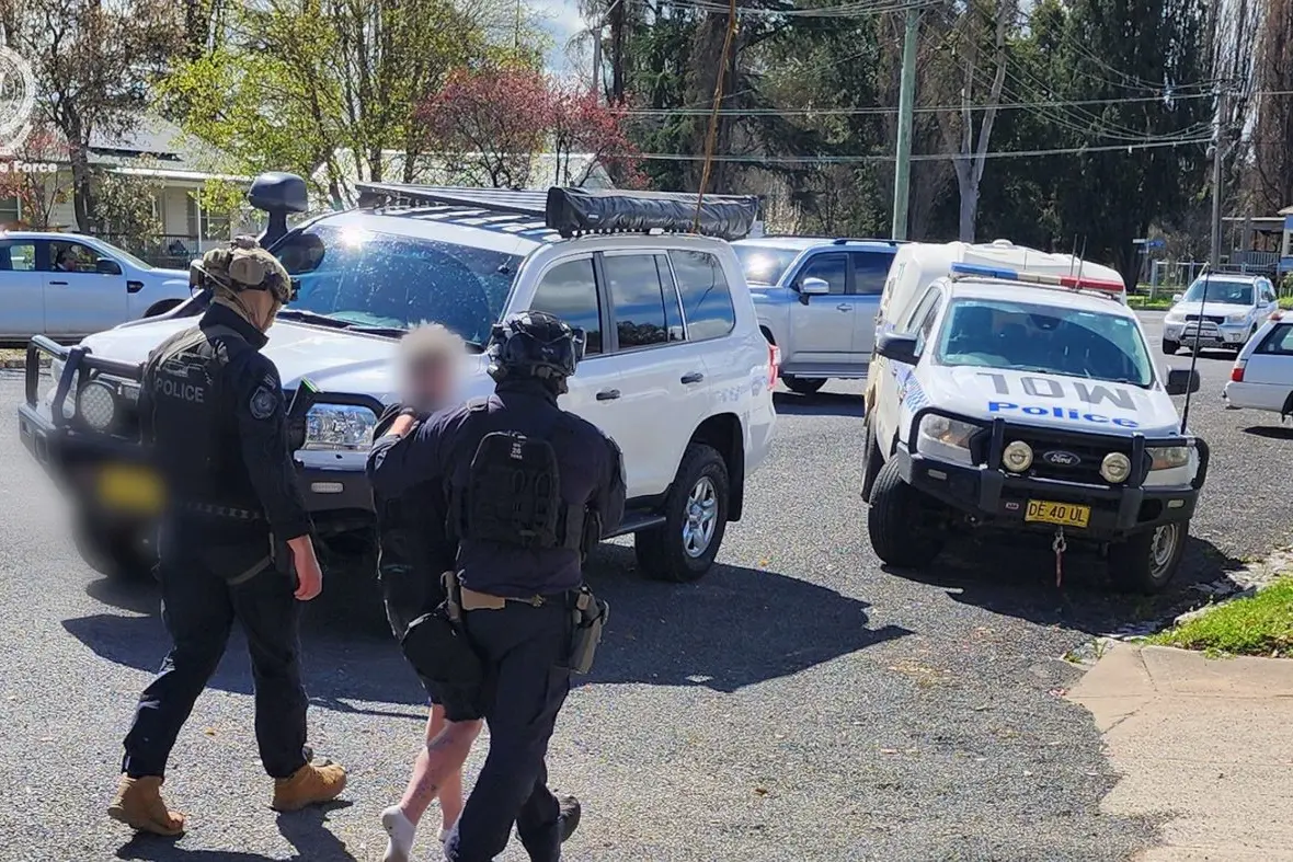 Specialist tactical officers stopped a vehicle in Gidley Street in Molong and arrested two men on Monday in relation to shots being fired at a home in Parkes. PHOTOS: NSW Police