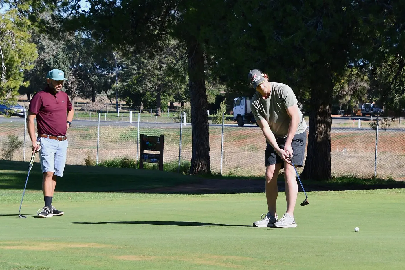 Luke Hodges watches as Nathan Swinga putts during a previous competition at the Parkes Golf Course. PHOTO: Jenny Kingham