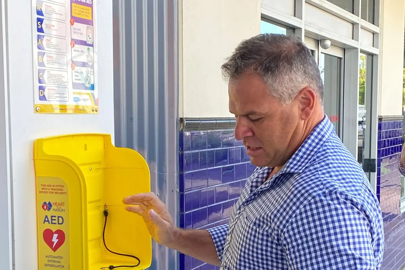 State Member for Orange Phil Donato with an automated external defibrillator (AED).