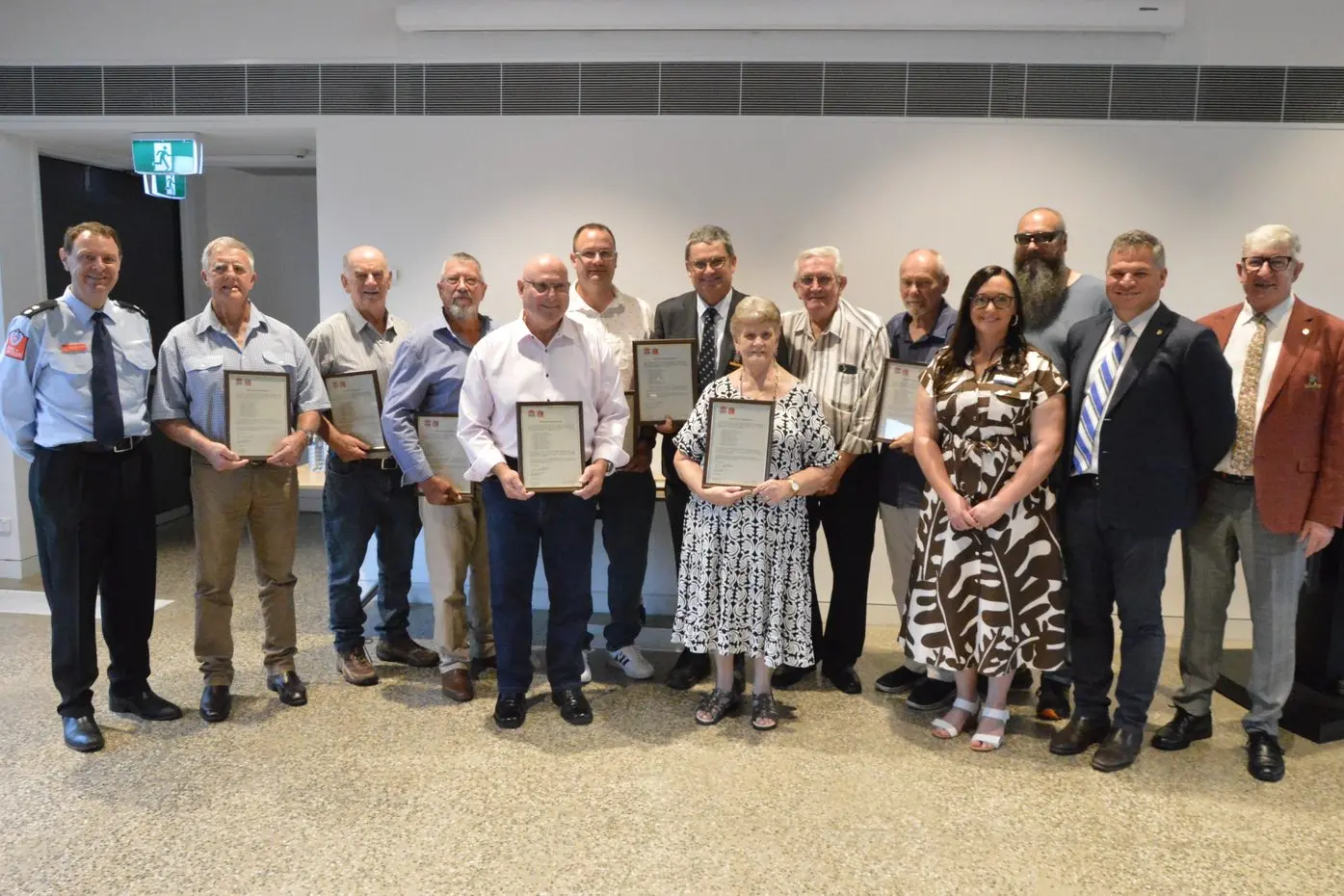The 10 firefighters from Parkes were finally recognised for their heroics in fighting the 1983 fuel depot fire in East Street at a ceremony on Tuesday. From left, Fire and Rescue NSW Commander of Region Zone West Superintendent Anthony Hojel, Robert Tinker, Graham Dixon, Don Jewell, Graham Thompson, Grant Ashcroft, Mayor Neil Westcott, Adrienne Bradley, Roger Larsen, Michael Shanks, Deputy Mayor Marg Applebee, David Shanks, Orange MP Philip Donato and Cr Bill Jayet.  PHOTOS: Christine Little