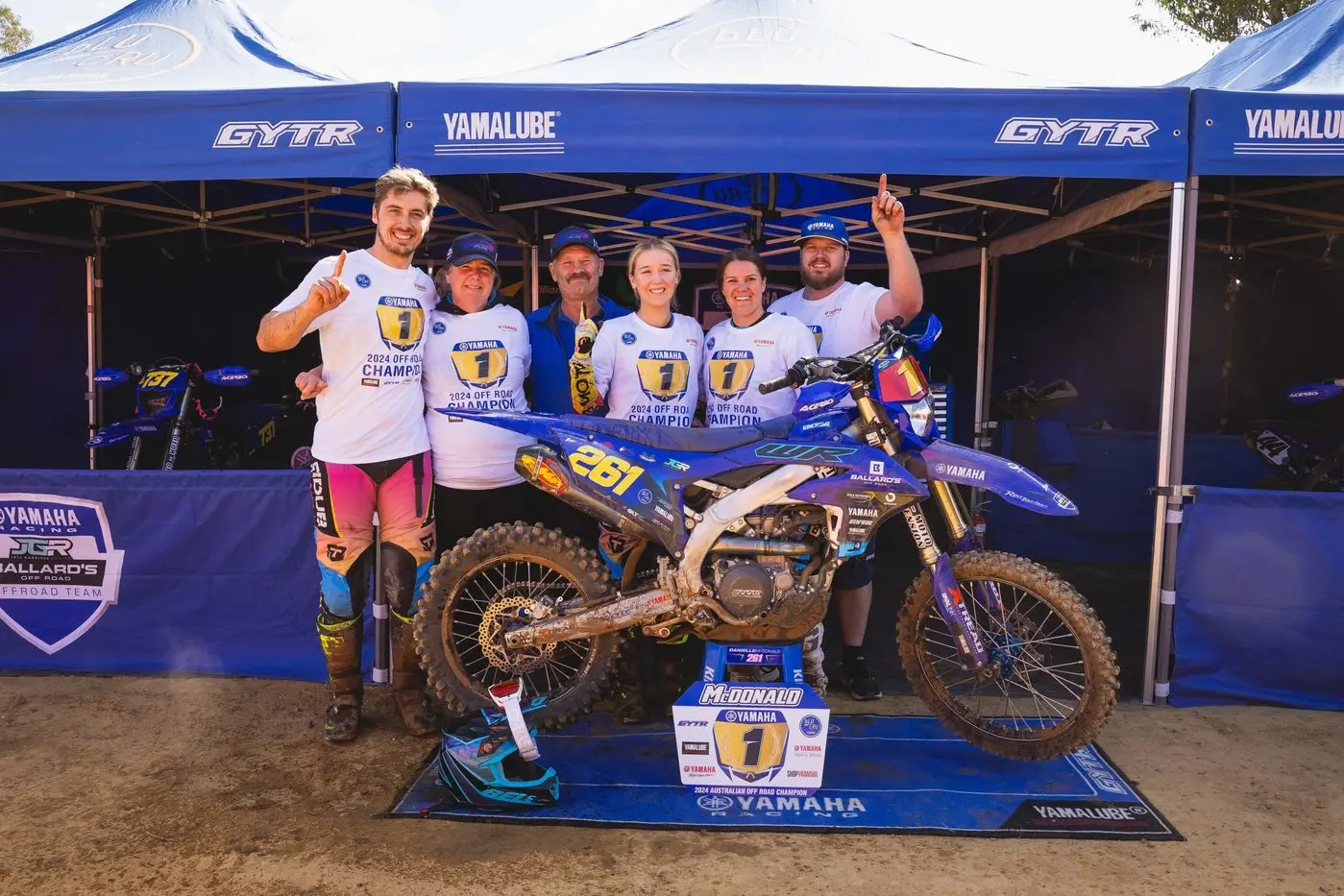 Danielle McDonald celebrating her first senior AORC championship win with her family and team.