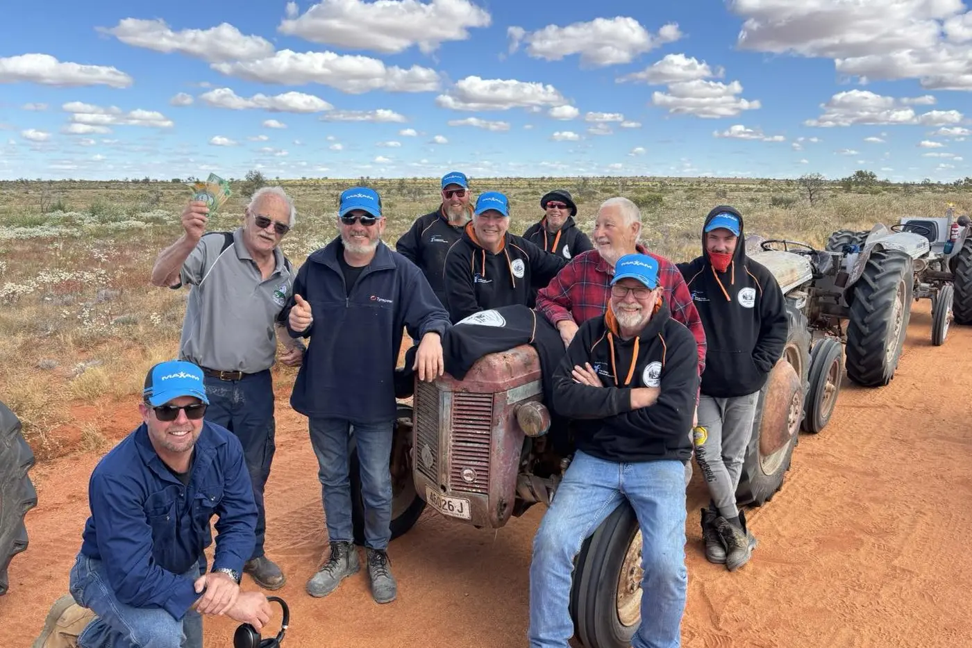 The Parkes Tractor Trekkers with John Montgomery who took a detour home from Cape York to meet up with the trekkers. John is proudly holding up his $500 donation to the cause. PHOTOS: Parkes Tractor Trekkers Facebook page
