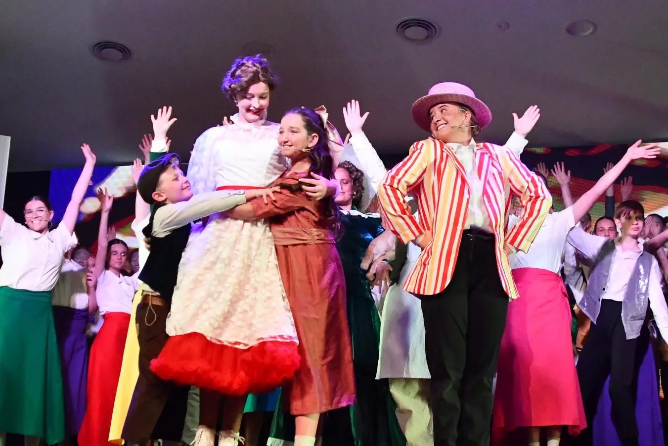 Joel Hurst (Michael Banks) and  Ella Denmead (Jane Banks) hug Angelique Bland (Mary Poppins) with Lexi Herden (Bert). PHOTOS: Jenny Kingham