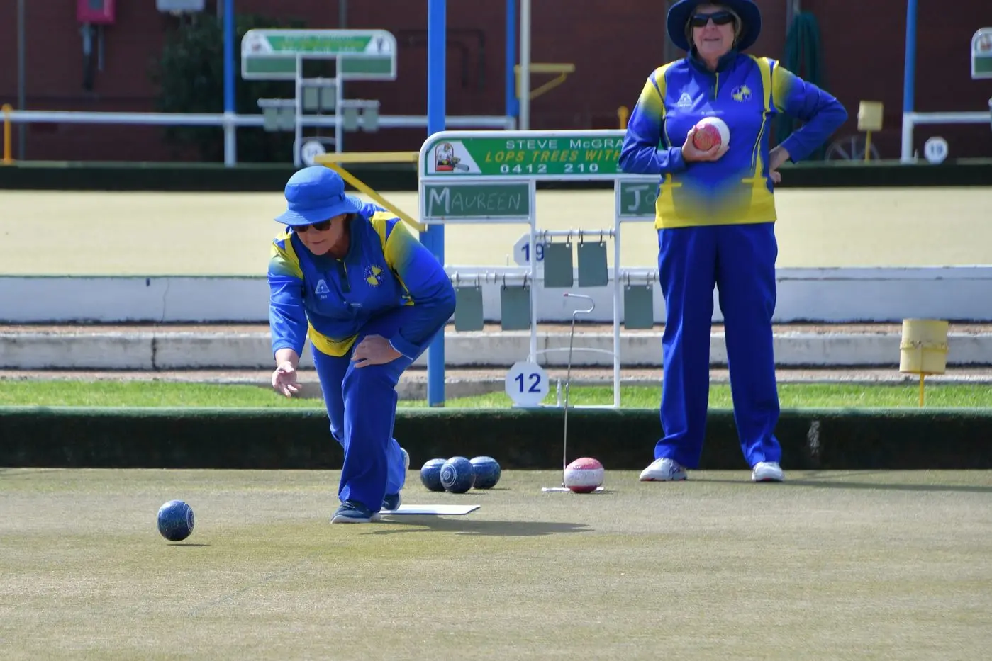 Jo Simpson bowls watched by Maureen Miller. Photo by Jenny Kingham