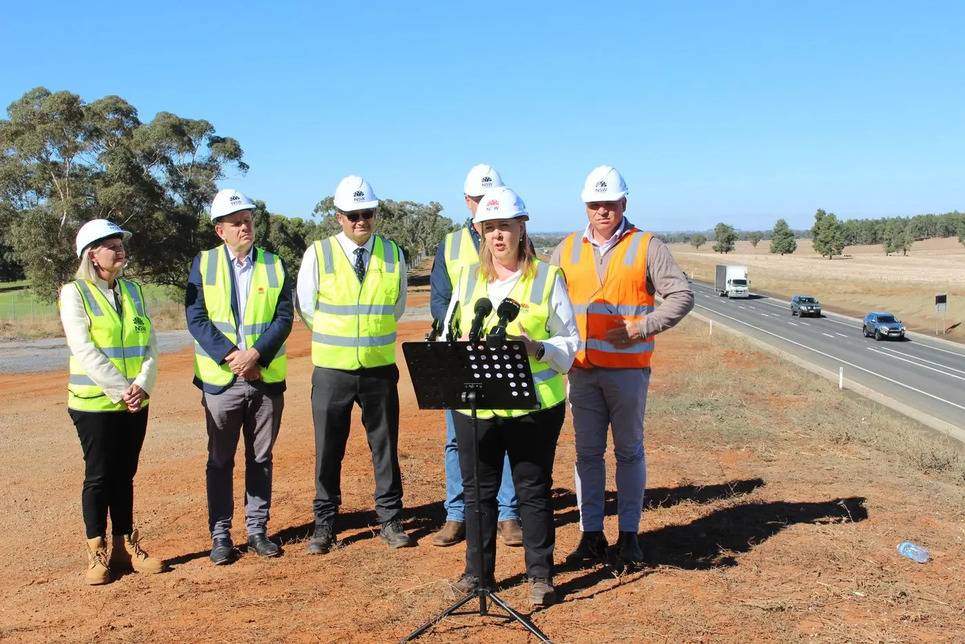Marking the opening of the Parkes Bypass were Transport for NSW Acting Regional Director West Holly Davies, MLC for Orange and Dubbo Stephen Lawrence, Parkes Shire Mayor Neil Westcott, Parkes Business Chamber president Geoff Rice (obscured), Minister for Roads Jenny Aitchison, and State Member for Orange Phil Donato. PHOTOS: Christine Little