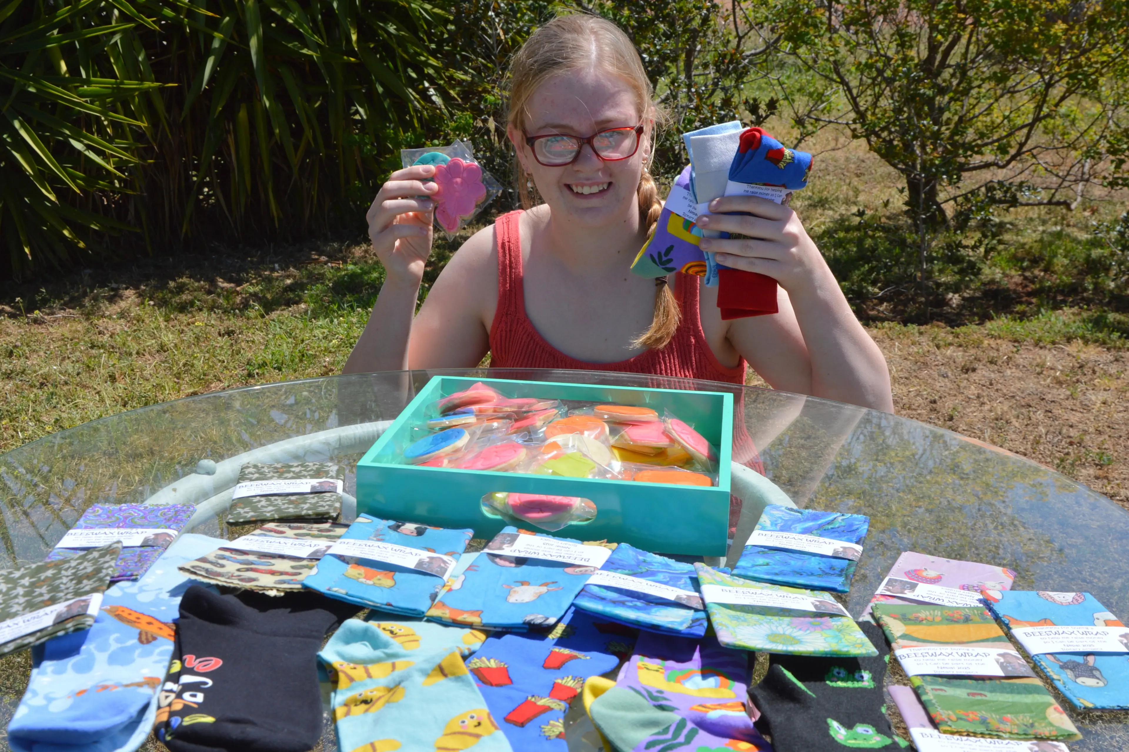<p>Marnie Noakes with her goodies she is selling to raise money to get to Nepal. PHOTO: Madeline Blackstock</p>\\n