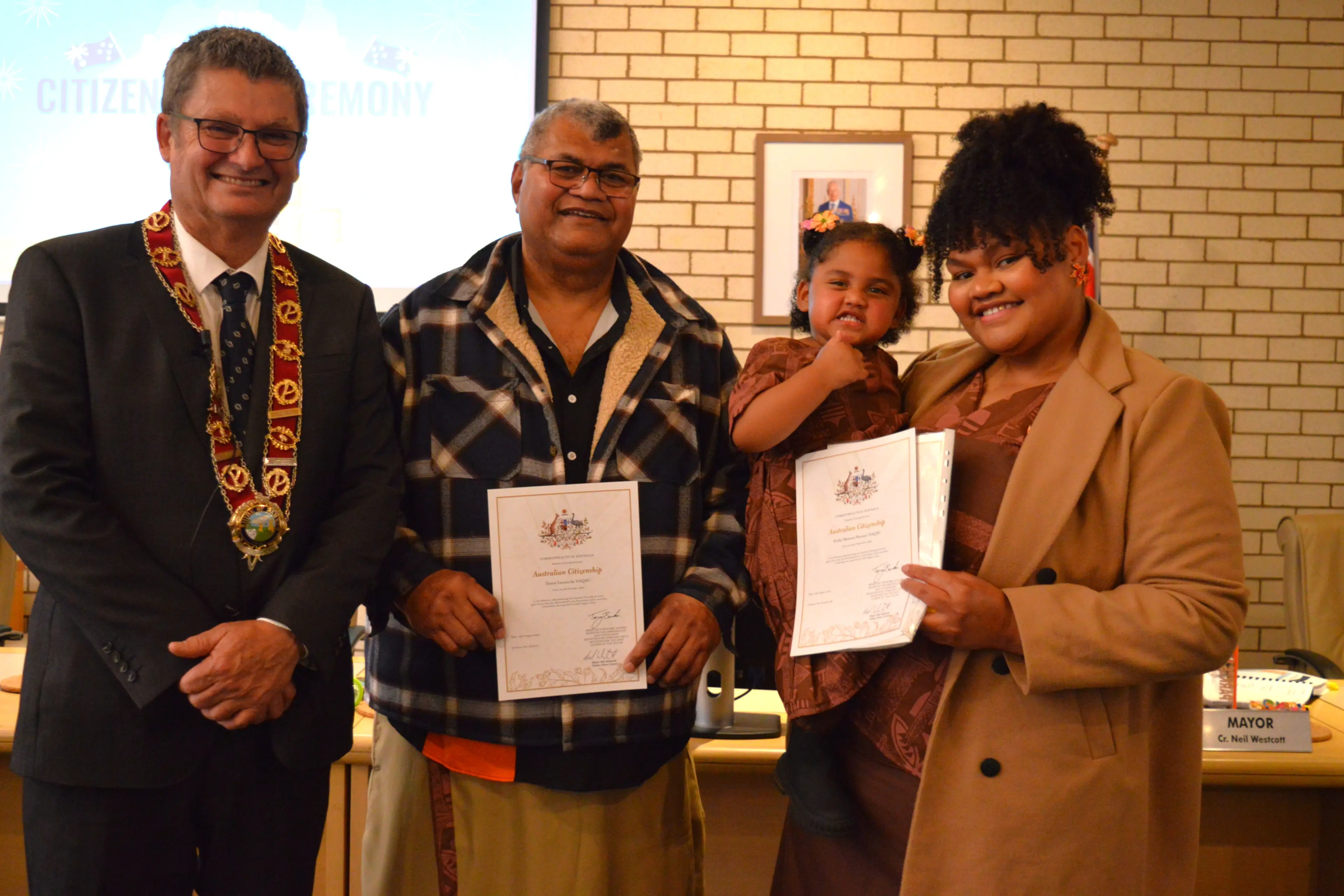 <p>Mayor Neil Westcott with Ilaitia (Elijah) Naqau from Fiji, his daughter Elisha Naqau and granddaughter Esther Naqau (2) at the citizenship ceremony. PHOTO: Christine Little</p>\\n