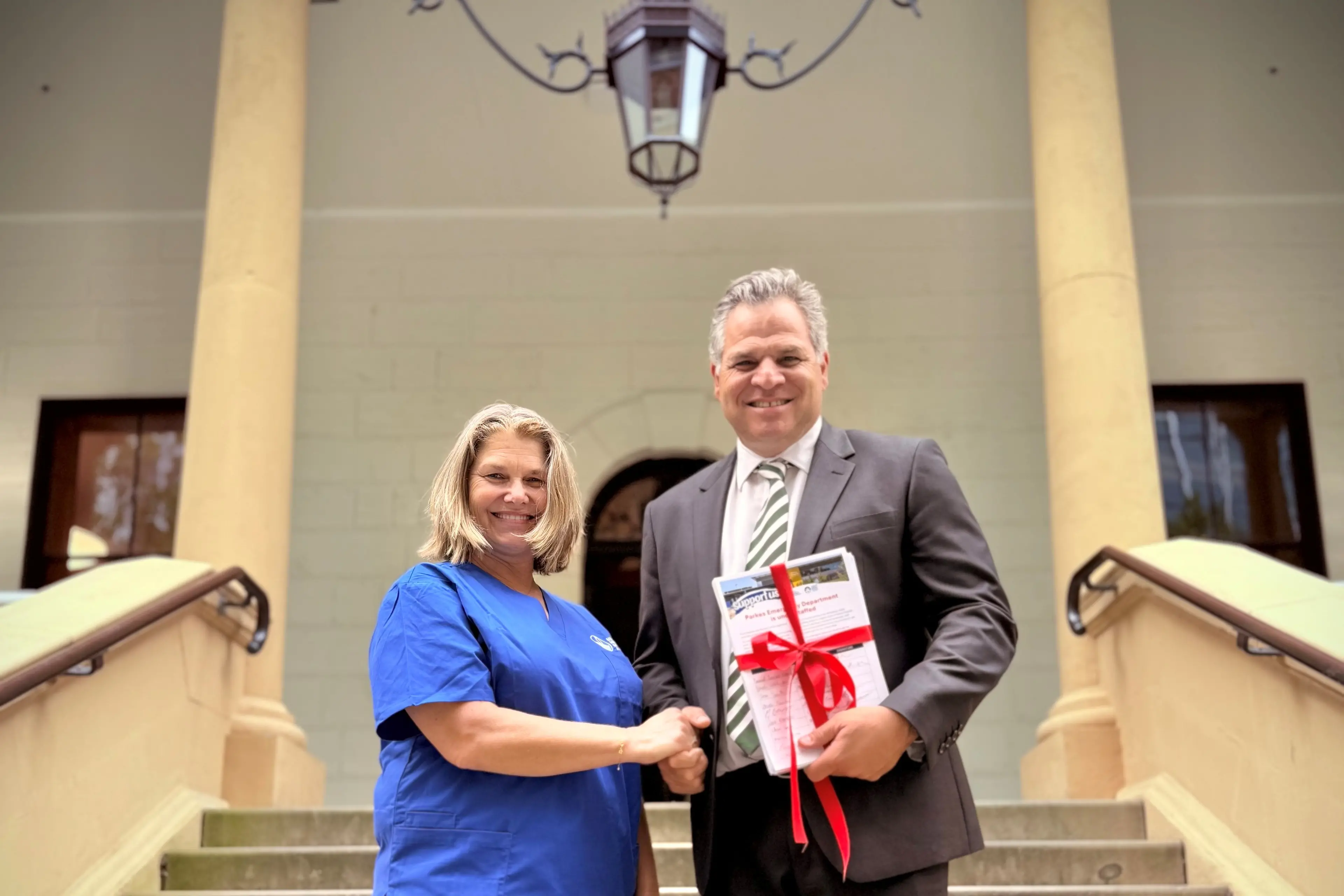 <p>Sarah Raymond of NSWNMA delivering Parkes nurses\\u2019 petition to Phil Donato last week on the steps of NSW Parliament.</p>\\n