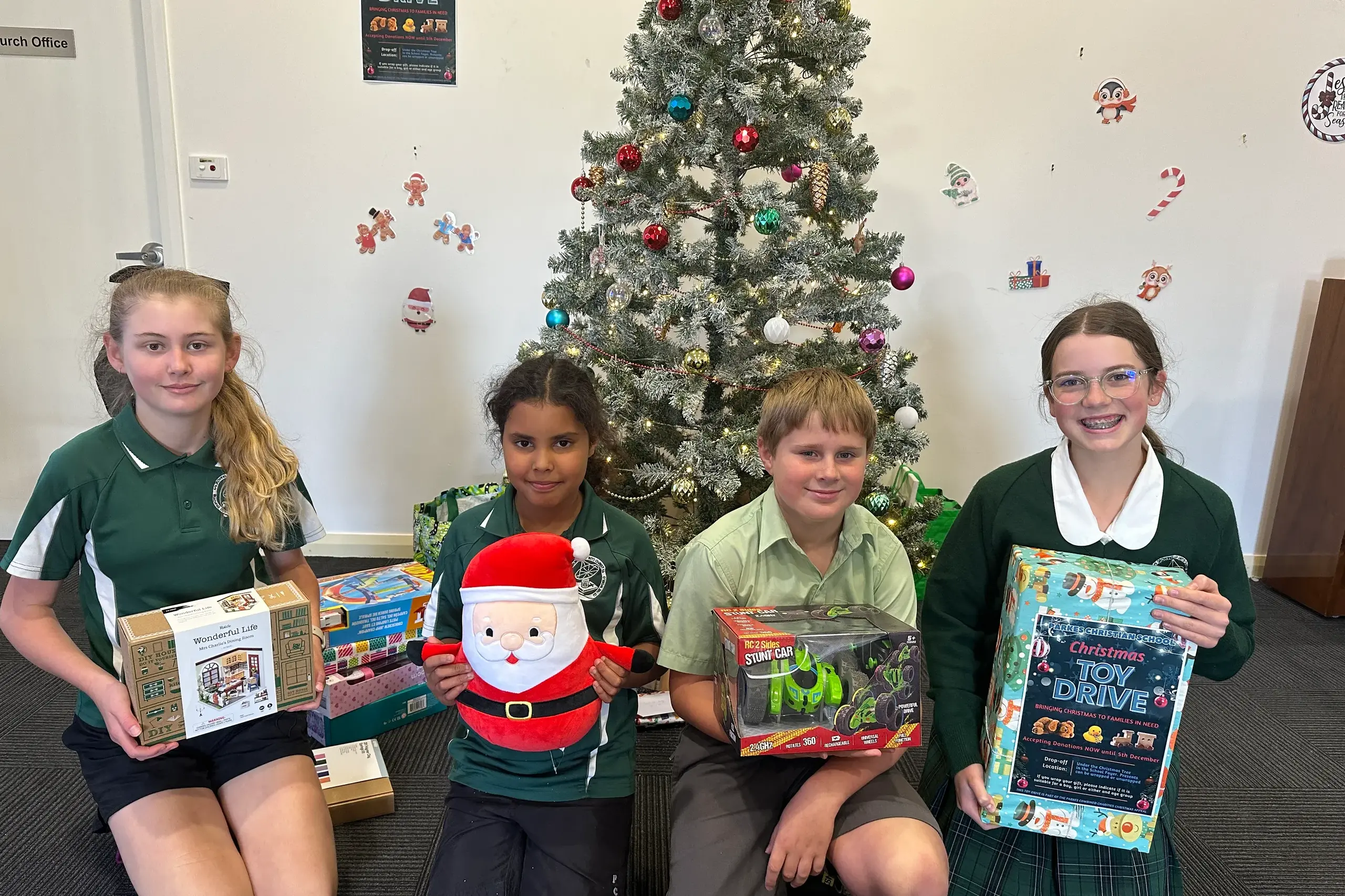 <p>Natasha Robinson, Sophia Biles, Joshua Walford and Lara Amery with some of the toys that Parkes Christian School students and families have donated to the Parkes Combined Charities Christmas Appeal.</p>\\n