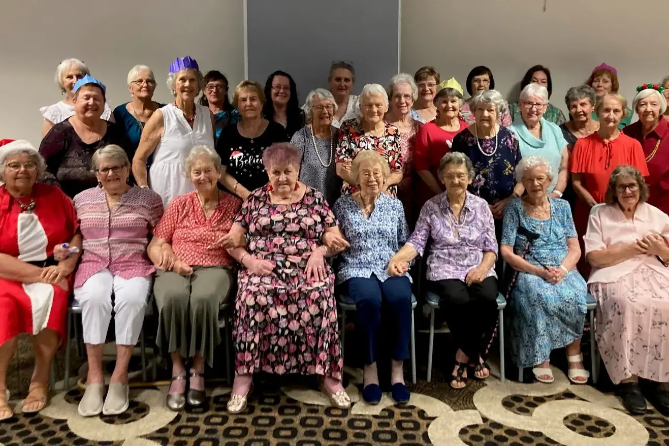<p>The group singing carols at the Anglican Women of St George\\u2019s Church\\'s Christmas party.</p>\\n