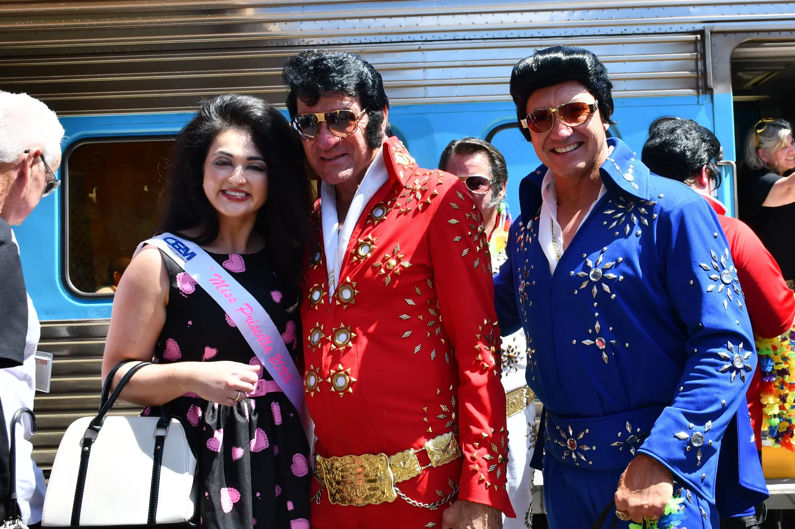 <p>2025 Miss Priscilla was welcomed off the Elvis Express by not one but two Elvi. PHOTO: Jenny Kingham</p>\\n