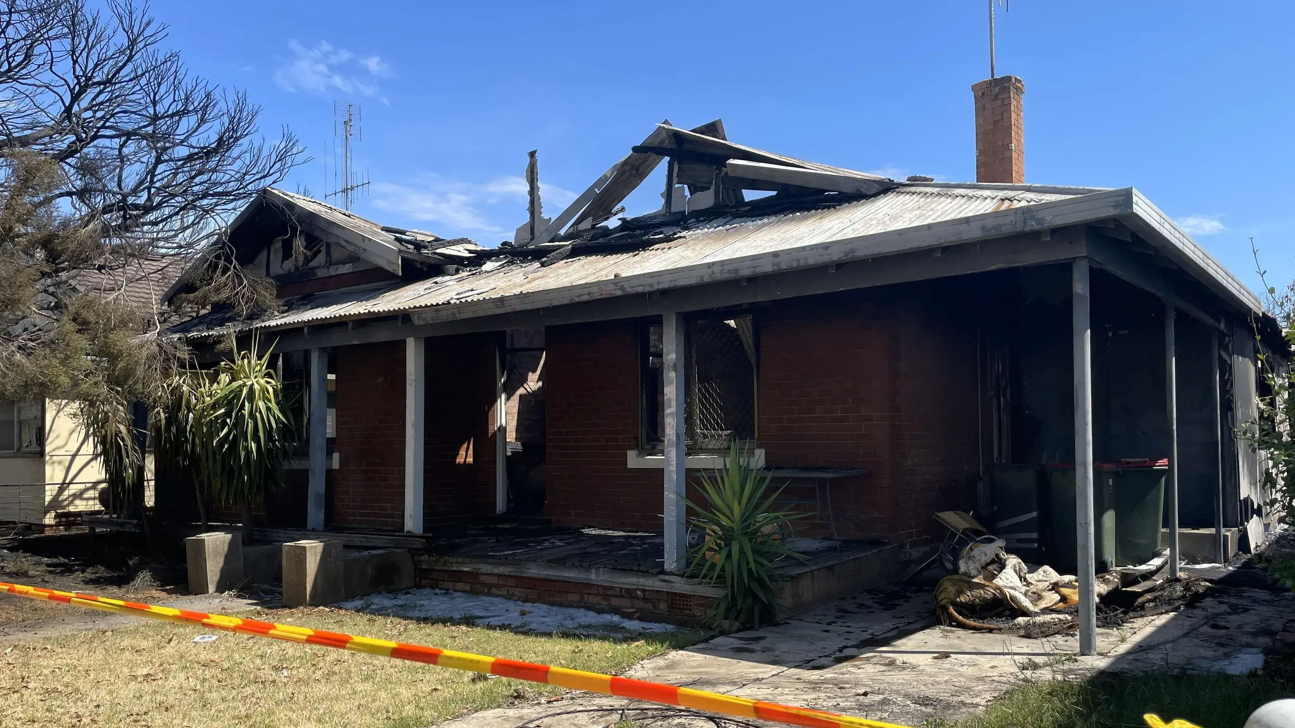 Raging fire destroys house, threatens two others