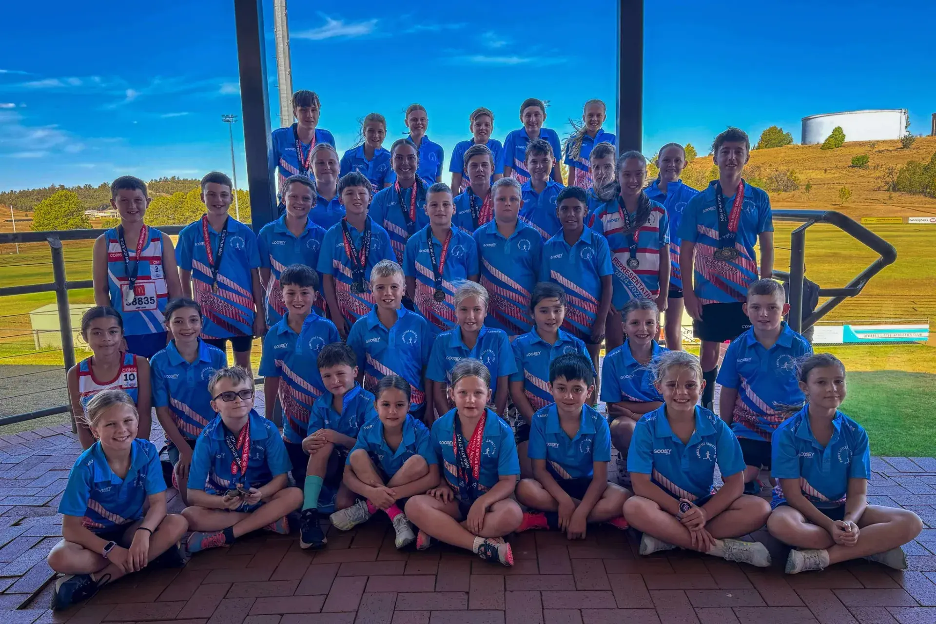 <p>Parkes Little Athletics athletes in their new representative shirts and some athletes with their medals they won at Regional Championships in Dubbo.</p>\\n