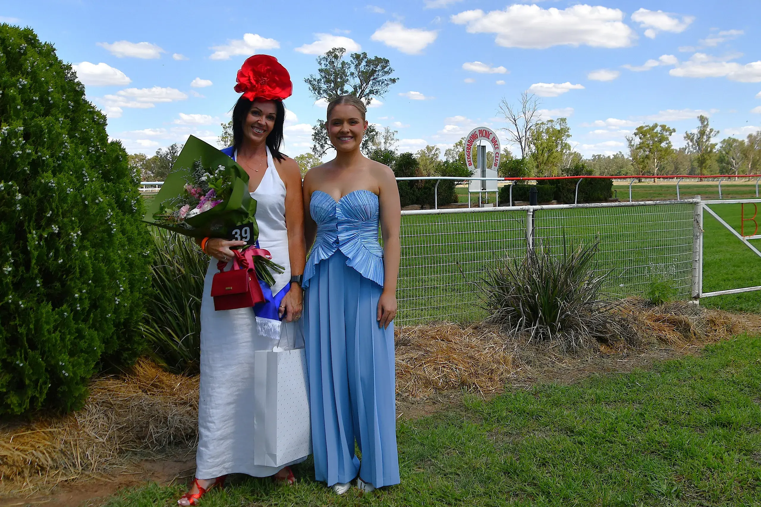 <p>Parkes Picnic Races president Fiona Glasheen won the Best Dressed Local Lady, congratulated by judge Georgie McMillan of Forbes. PHOTOS: Jenny Kingham</p>\\n