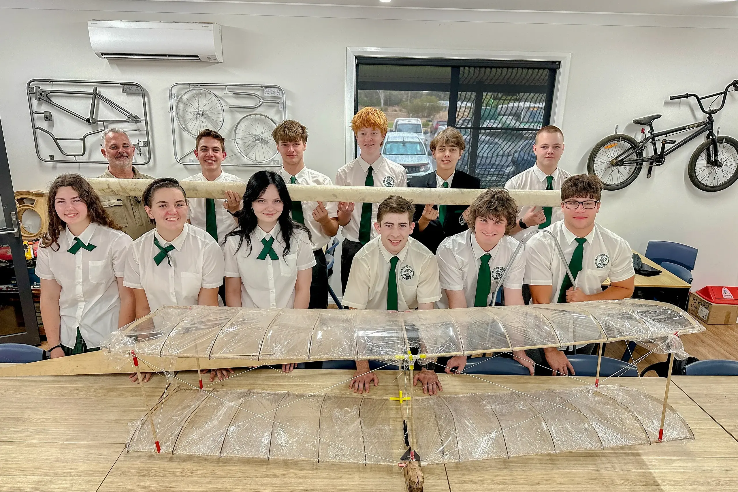 <p>Back, left to right, teacher Jason Wynstra, William Bligh, Oliver Neilsen, Xander Greef, Samuel Pearce, Lane Jones; front, Madison Wynstra, Bonnie Hall, Emily RIchards, Jack Greenland (pilot), Matthew Fredericks, Riley Pizzi.</p>\\n