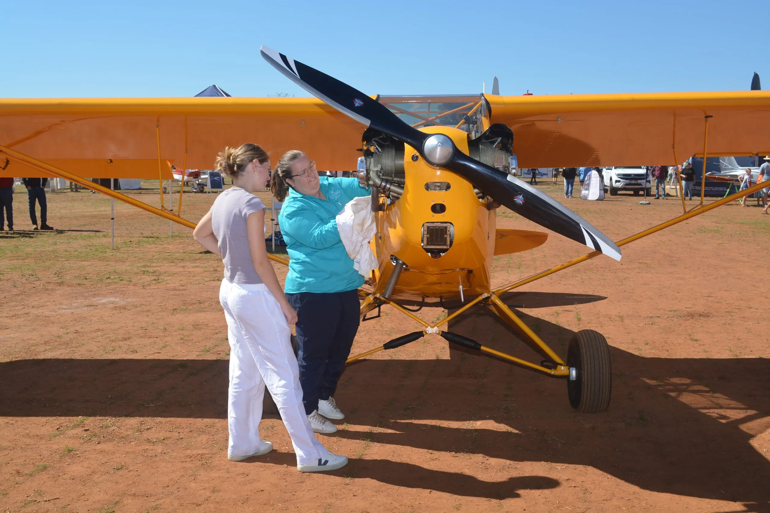 <p>Parkes girl Sophie McQuie takes a closer look at one of the many light aircraft on display at the event in 2024.</p>\\n