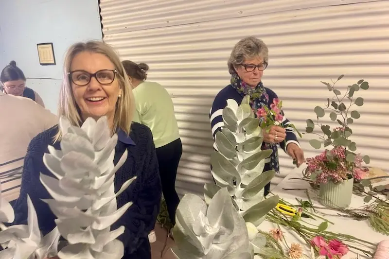 <p>Peak Hill sisters Cathy Bendall (left) and Sue van der Reyden took part in the flower arranging workshop using native flowers hosted by the Peak Hill PA & H Association thanks to a cultural grant.</p>\\n