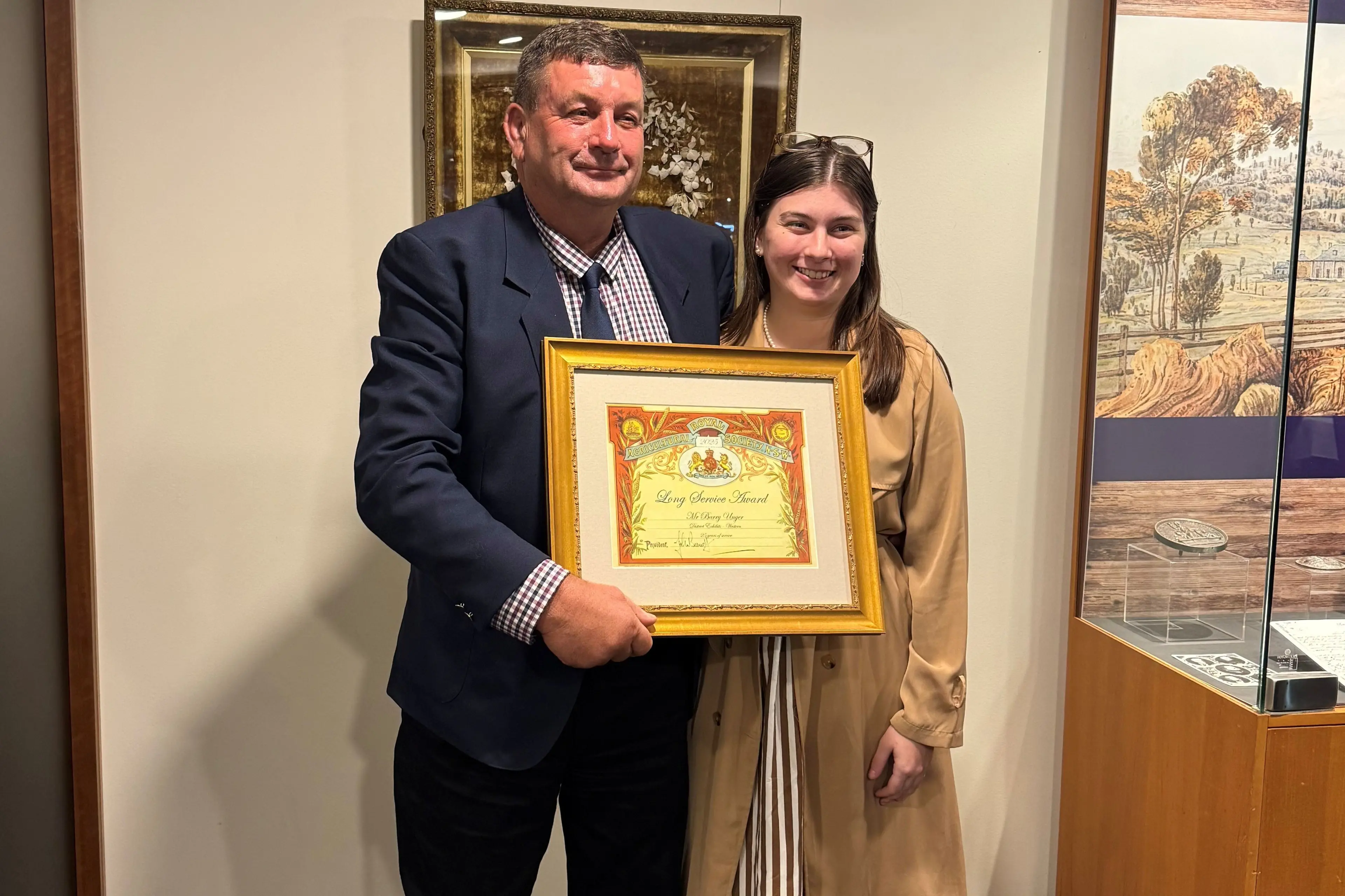 <p>Barry Unger with his daughter Tenaya Unger after receiving his 25-year service award from the Royal Agricultural Society of NSW.</p>\\n