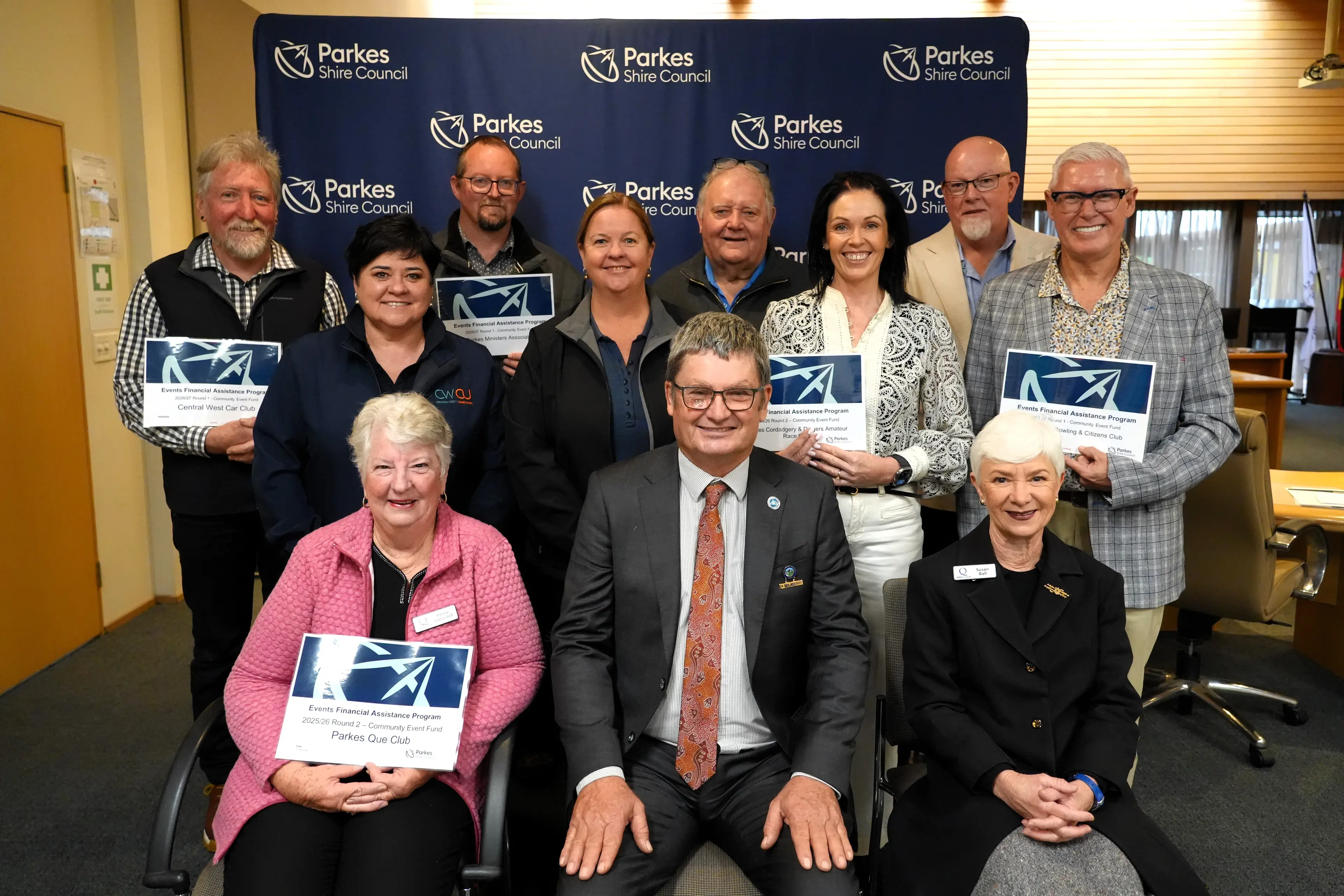 <p>Present for the announcement of grant recipients were, back, Jeff McClurg (Central West Car Club), Craig Bland (Parkes Ministers Association), Paul Thomas (Parkes RSL Sub-Branch), David Lewis and Alan Flaval (far right) both of Tullamore Bowling and Citizens Club; middle, Kel Spedding, Trisha Trim, and Fiona Glasheen (all of Parkes Coradgery and Diggers Club); front, Parkes Shire mayor Neil Westcott (centre) with Kerrie Churchill and Susan Ball from Parkes Que Club who also received $8500 in the previous round.</p>\\n
