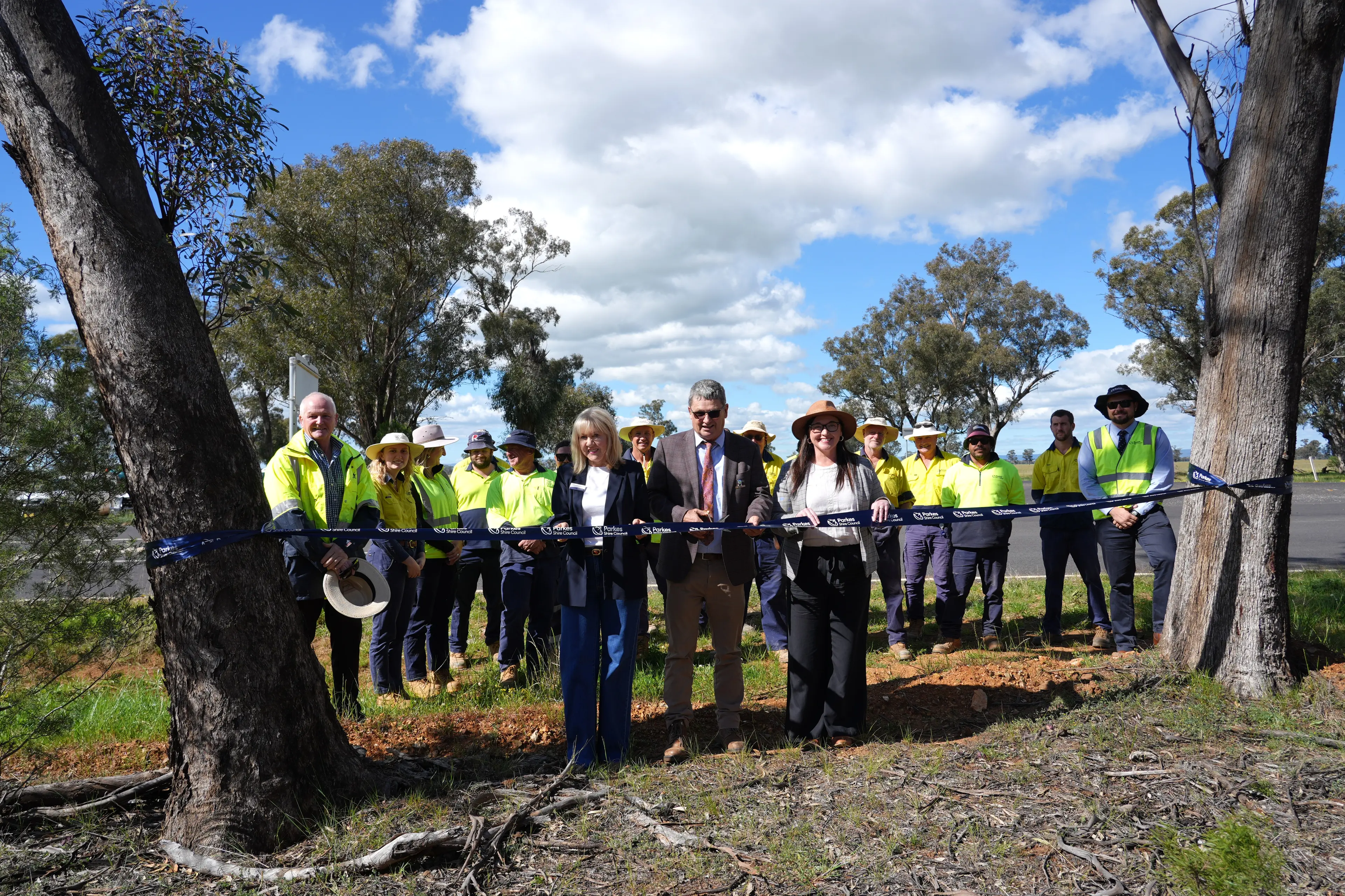 <p>Cr Joy Paddison, Mayor Neil Westcott and Cr Marg Applebee cut the ribbon to officially open the Bogan Road upgrade, with general manager Kent Boyd (left) and director of operations Logan Hignett (right), and the construction team.</p>\\n